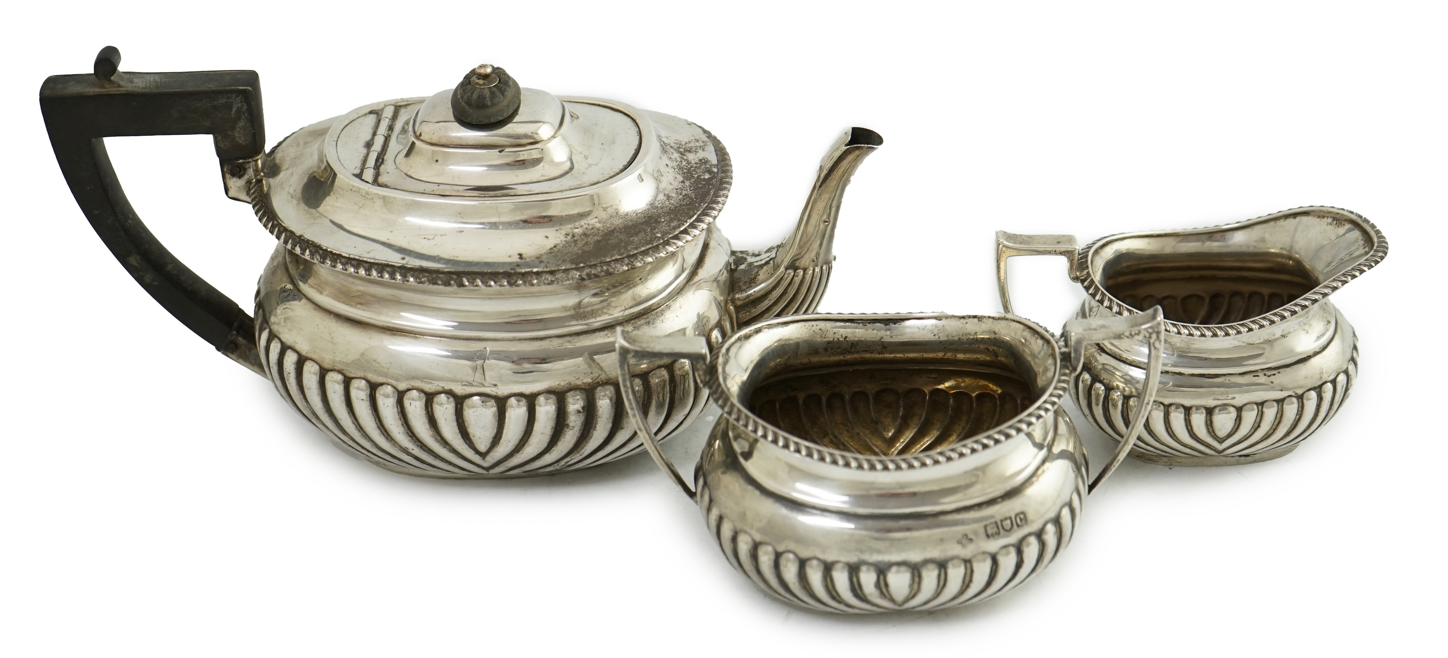 A late Victorian demi-fluted silver three piece tea set, by Horace Woodward & Co Ltd